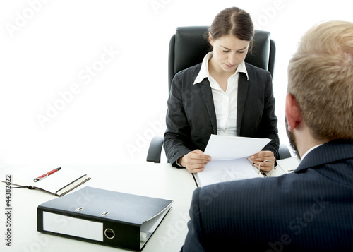 Photo: beard business man brunette woman at desk read contract beard business man brunette woman at desk read contract