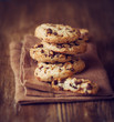Photo: Stacked chocolate chip cookies on brown napkin Stacked chocolate chip cookies on brown napkin