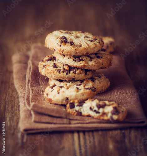 Photo: Stacked chocolate chip cookies on brown napkin Stacked chocolate chip cookies on brown napkin