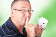Man with four aces holding finger to mouth