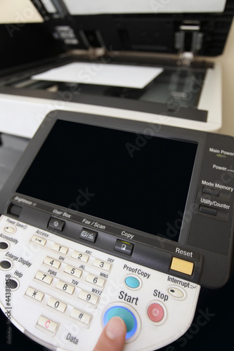 Photo: Finger pressing of keyboard buttons of the laser copier Finger pressing of keyboard buttons of the laser copier