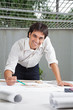 Foto: Male Architect Working On Blueprint Male Architect Working On Blueprint