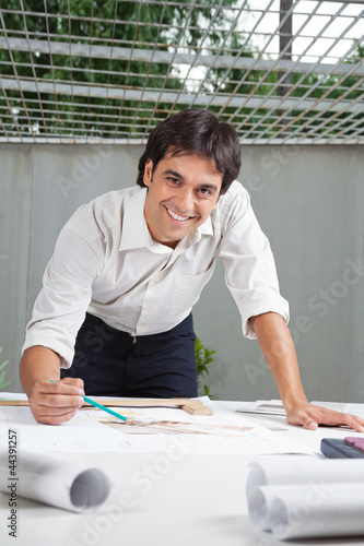 Photo: Male Architect Working On Blueprint Male Architect Working On Blueprint