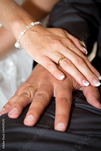 Photo: Married couple holding hands together with wedding rings Married couple holding hands together with wedding rings