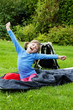 happy little girl resting in a sleeping bag - camping concept