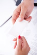Businessman passes business card to his partner