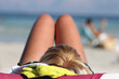 Blond woman sunbathing on beach