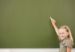 Photo: Scoolgirl standing near blackboard Scoolgirl standing near blackboard