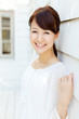 Photo: Beautiful young woman standing on terrace. Portrait of asian. Beautiful young woman standing on terrace. Portrait of asian.