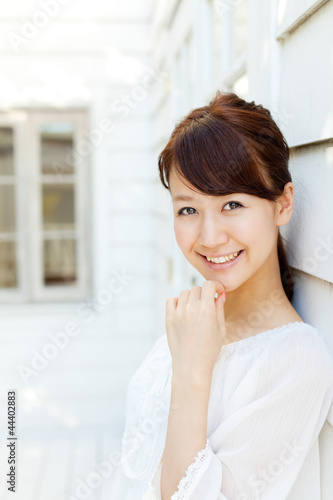 Photo: Beautiful young woman standing on terrace. Portrait of asian. Beautiful young woman standing on terrace. Portrait of asian.