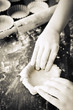 Baker pinching dough into moulds