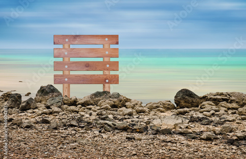 Photo: Wooden sign in seascape area Wooden sign in seascape area