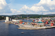 Foto: Small port. Containers are on shore. Cranes load cargo on ship Small port. Containers are on shore. Cranes load cargo on ship