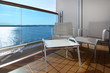 Foto: balcony with white chairs and table on ship with view on sea balcony with white chairs and table on ship with view on sea