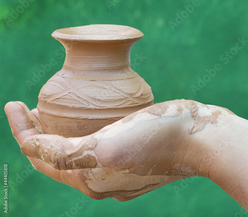 Photo: Close-up of hand holding pottery an jar Close-up of hand holding pottery an jar