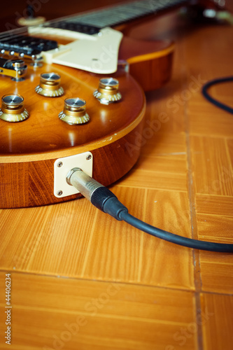 Photo: electric guitar on floor with cable electric guitar on floor with cable