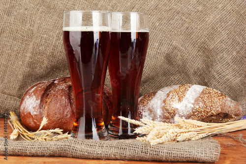 Photo: two glasses of kvass with bread on canvas background close-up two glasses of kvass with bread on canvas background close-up