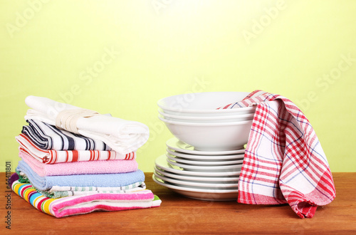 Photo: kitchen towels with dishes on green background close-up kitchen towels with dishes on green background close-up