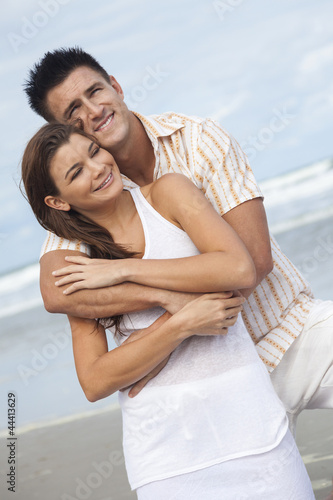 Photo: Man and Woman Couple Embracing On A Beach Man and Woman Couple Embracing On A Beach
