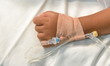 Hand of sick child, intravenose set infusion.