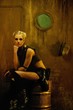 Blond girl in a bunker sitting on a barrel