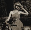 Woman in retro dress with a scooter
