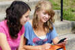 Two students reading on cell phone