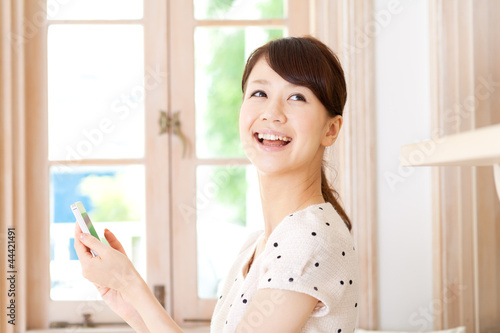 Photo: Beautiful young woman using a mobile phone. Portrait of asian. Beautiful young woman using a mobile phone. Portrait of asian.