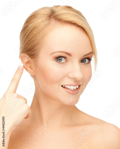 Photo: beautiful woman pointing to ear beautiful woman pointing to ear