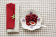Homemade cornel preserve on a china plate with a silver dessert