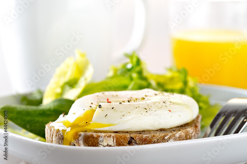 Photo: poached egg on toast with green salad and orange juice poached egg on toast with green salad and orange juice