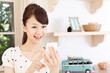Beautiful young woman using a mobile phone. Portrait of asian.