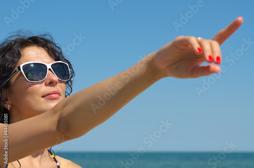 Photo: Woman in sunglasses pointing Woman in sunglasses pointing