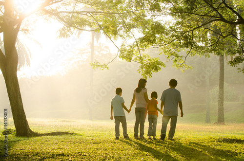 Photo: a family walking in the park a family walking in the park