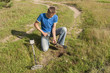Treasure search with metal detector.