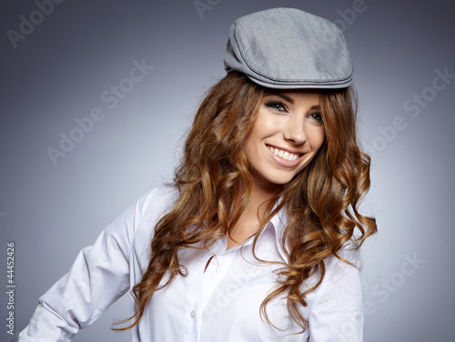 Photo: autumn student smiling against a grey background autumn student smiling against a grey background