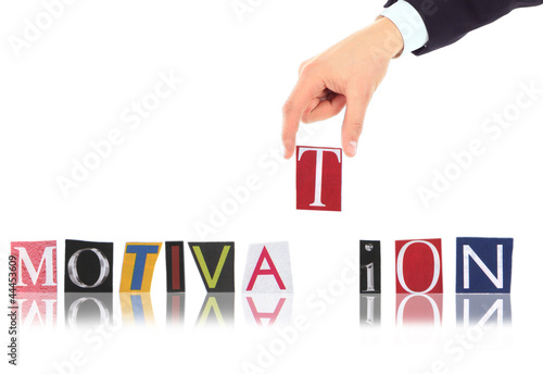 Photo: Hand and word Motivation isolated on white background Hand and word Motivation isolated on white background