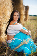 portrait of a girl next to haystack