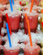 Fresh juice in plastic cups with tubes for drinking