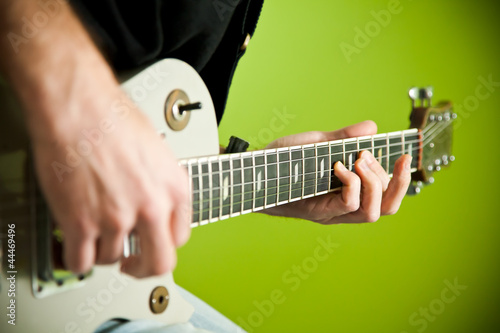 Photo: Close up of an electric guitar being played. Close up of an electric guitar being played.