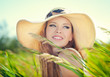 Beautiful woman face on summer meadow