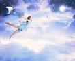 Foto: Little girl flying into the blue night sky Little girl flying into the blue night sky