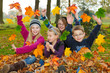 children playing with autumn leaves