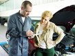 Photo: Master mechanic and customer looking at the repair costs Master mechanic and customer looking at the repair costs