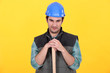 Manual worker stood with large hammer