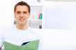 Young man at home with a book