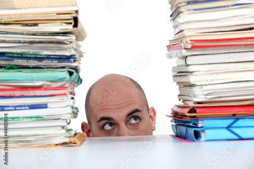 Photo: Man peering at files Man peering at files