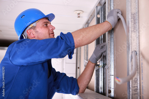 Photo: Electrician installing wiring Electrician installing wiring
