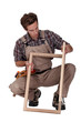 Furniture maker constructing wooden frame