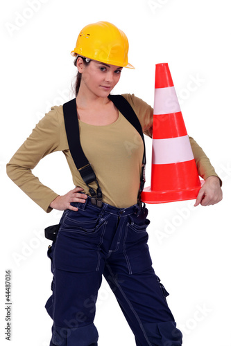 Photo: craftswoman holding traffic cone craftswoman holding traffic cone